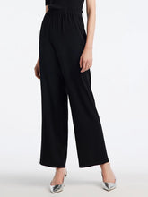 a woman in black culottes pants